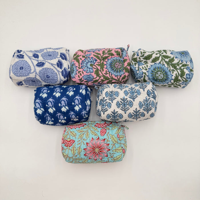 Set of six floral-patterned fabric pouches on a white background
