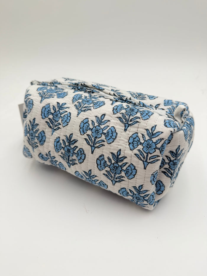 Folded fabric with blue floral pattern on a white background