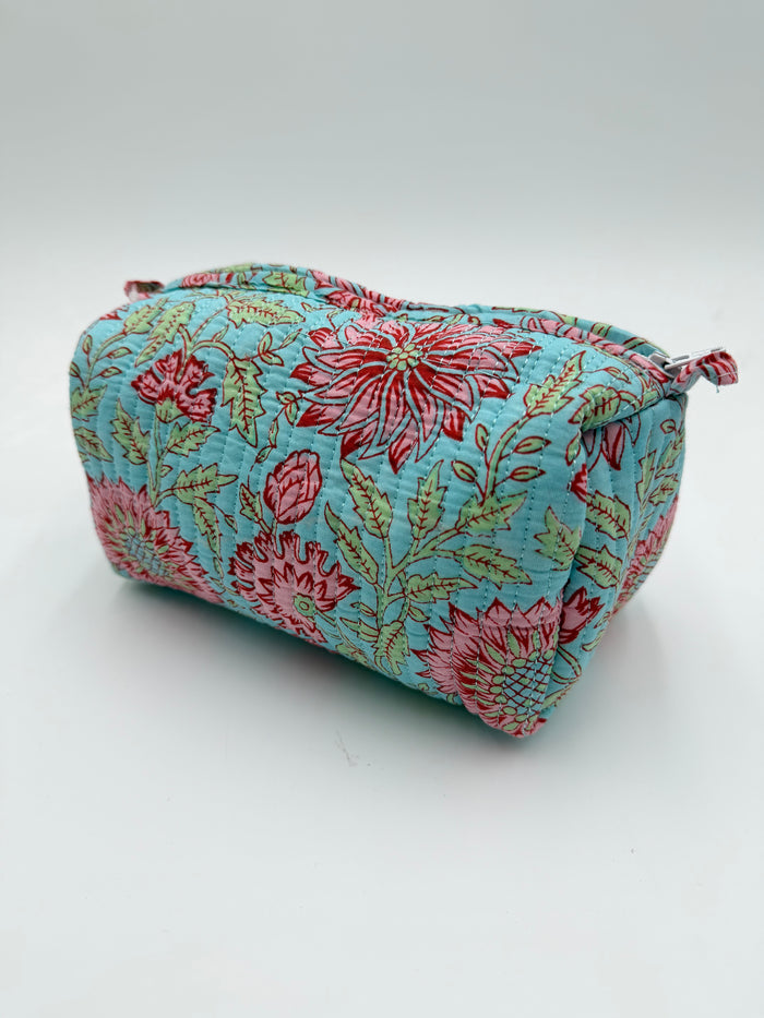 Floral-patterned fabric pouch on a white background