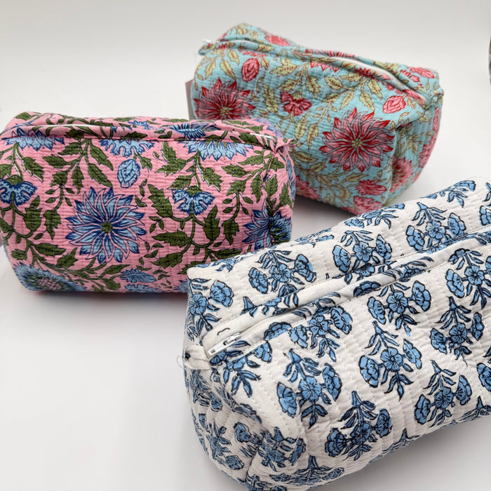 Three floral-patterned pouches on a white background