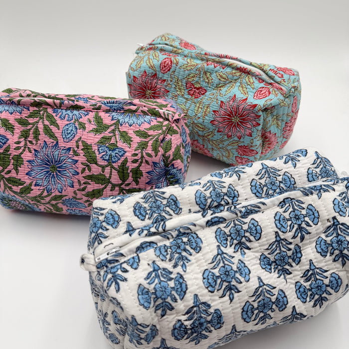 Three floral-patterned fabric bags on a white background