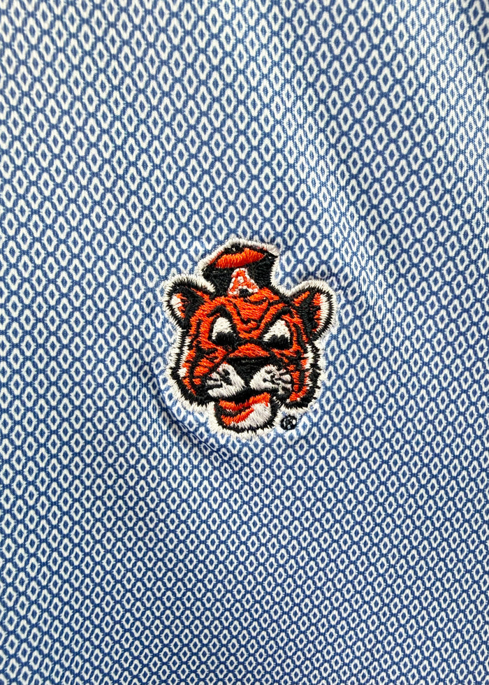 Close-up of a light blue textured polo shirt featuring an embroidered tiger mascot logo with a white 'A' on its forehead.