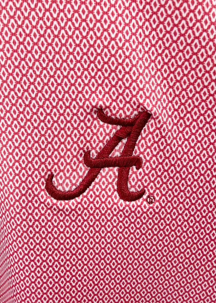 Close-up of a red embroidered Alabama 'A' logo on a red and white micro-patterned fabric background.
