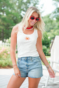girl wearing white tank with beaded crab