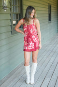 Girl in burgundy floral set with knee high cream boots