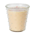 Candle in a decorative glass holder with a beaded rim on a white background