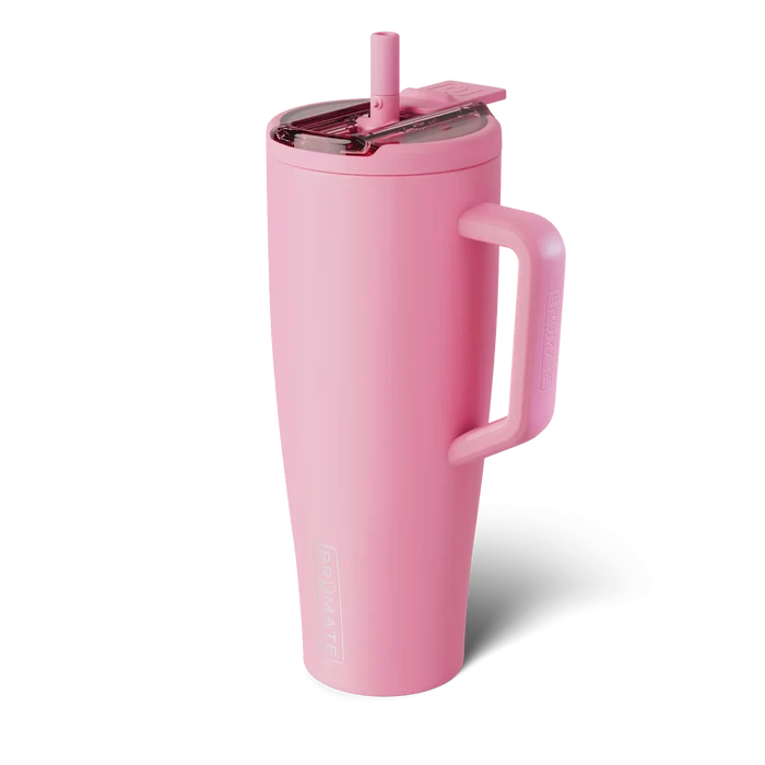 Pink insulated tumbler with handle on a white background