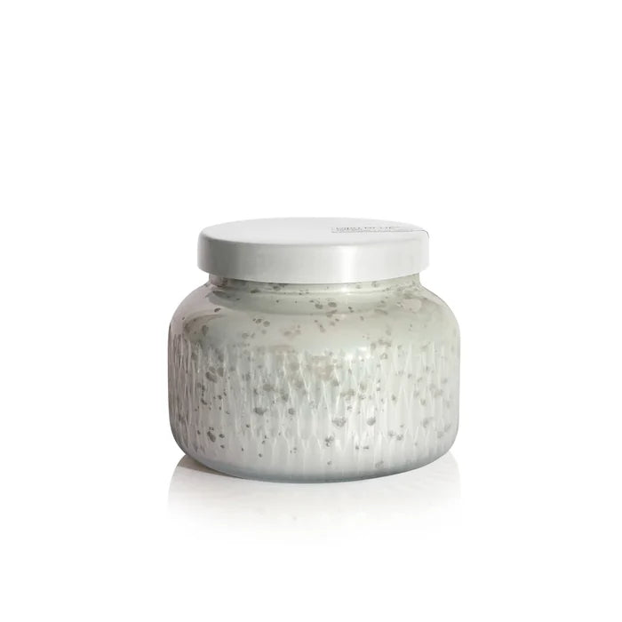 Silver jar with textured surface on a white background