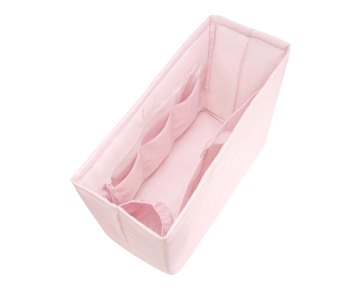 Pink baby bathtub with soft mesh sides on a white background