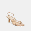 Beige sandal with thin straps on a light beige background
