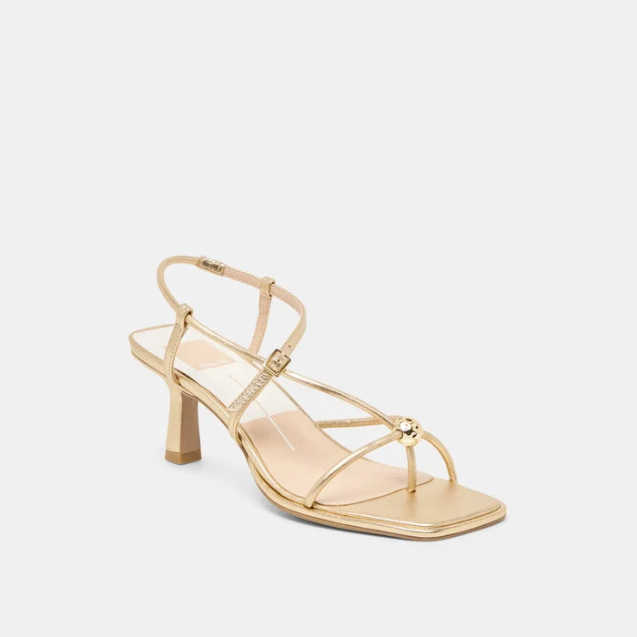 Gold high-heeled sandal on a light gray background