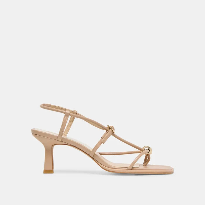 Beige sandal with thin straps on a light beige background