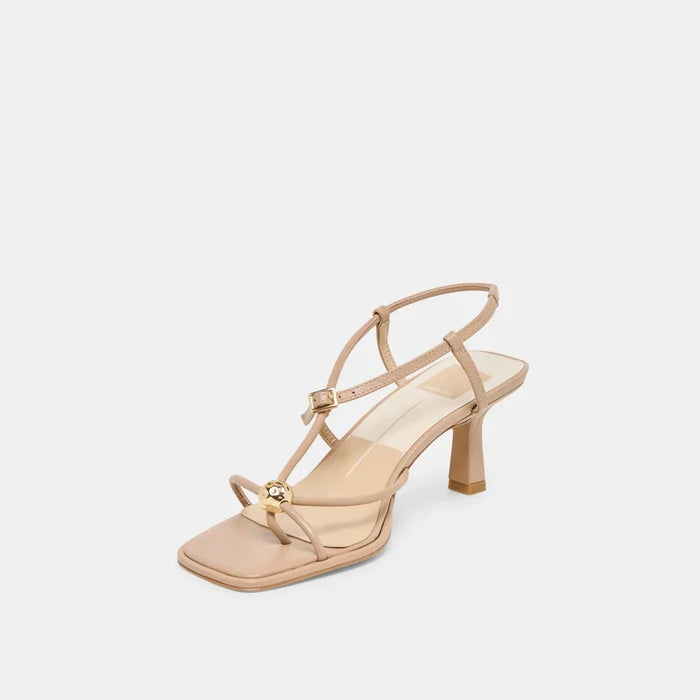 Beige sandal with a gold buckle on a light gray background