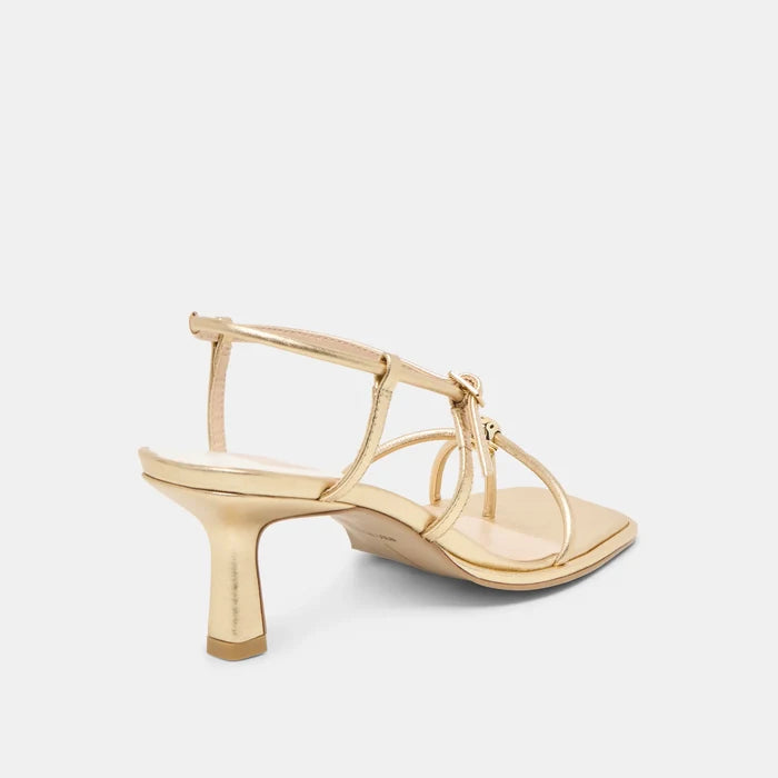 Gold high-heeled sandal on a light gray background