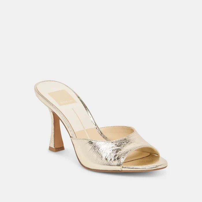Gold high-heeled shoe on a white background