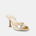 Gold high-heeled shoe on a white background