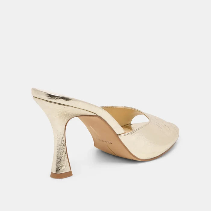 Gold high-heeled shoe on a white background