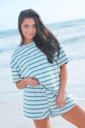 Woman wearing a striped outfit on a beach
