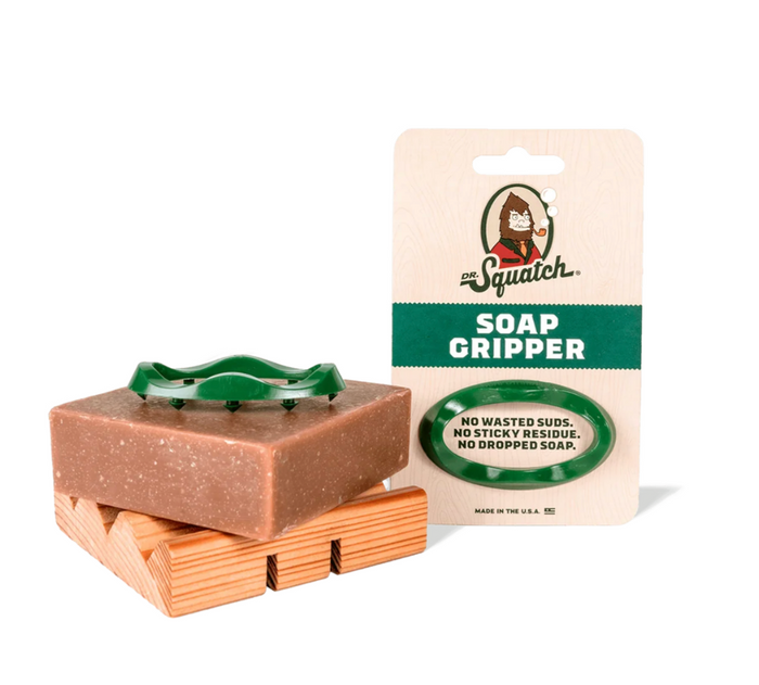 Bar of soap on a wooden holder with a packaging labeled 'Soap Gripper' on a white background.