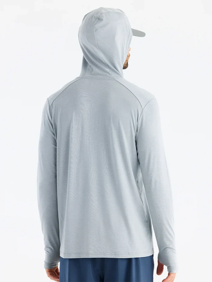 Person wearing a gray hoodie on a white background
