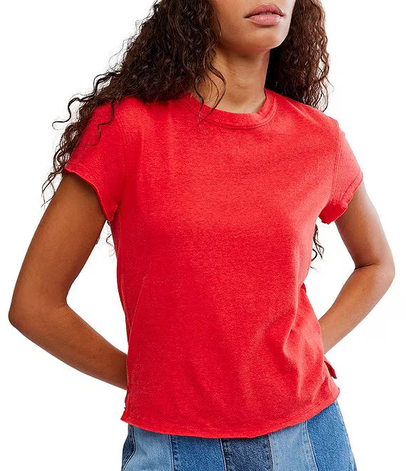 Person wearing a red t-shirt and blue jeans on a white background