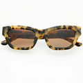Sunglasses with tortoiseshell frame and brown lenses on a white background