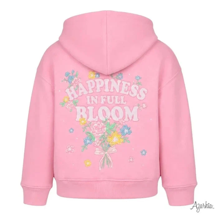 A pink hooded sweatshirt shown from the back, featuring a colorful floral graphic and the text 'HAPPINESS IN FULL BLOOM' in white. The brand name 'Azorkia' is visible in a script watermark in the bottom right corner.