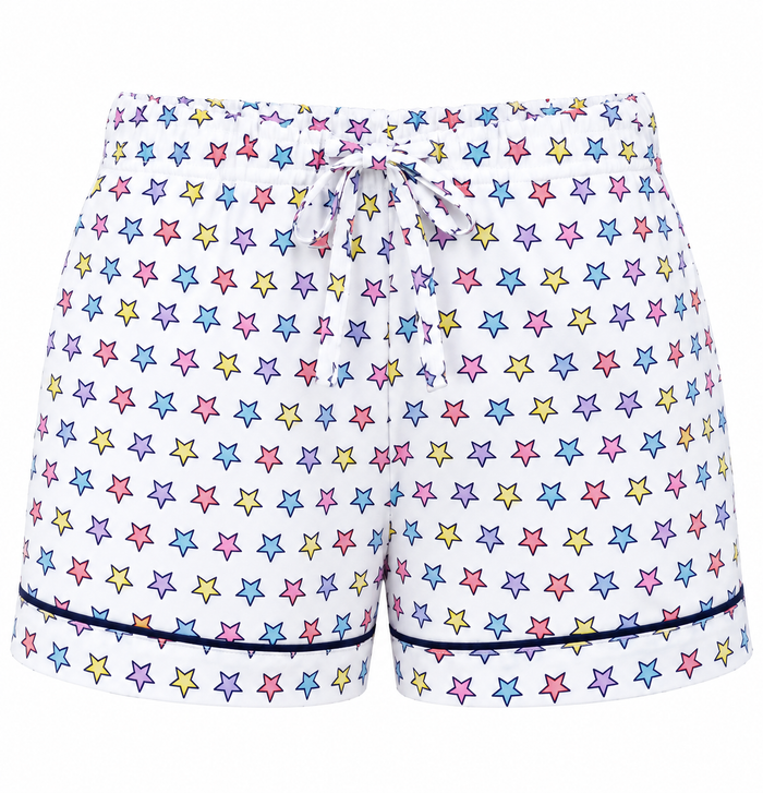 White drawstring shorts covered in a colorful pattern of outlined stars in pink, blue, yellow, and purple, finished with dark piping along the hem.