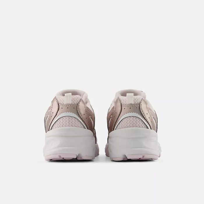 A pair of low-top sneakers shown from the back, featuring a dusty rose and light gray mesh upper with thick white chunky soles, set against a plain light gray background.