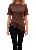 A woman modeling a brown short-sleeve top with a scalloped lace hem, paired with black pants and brown ankle boots, shown against a white background with a faint checkerboard pattern.