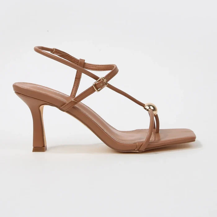 Brown sandal with thin straps on a white background