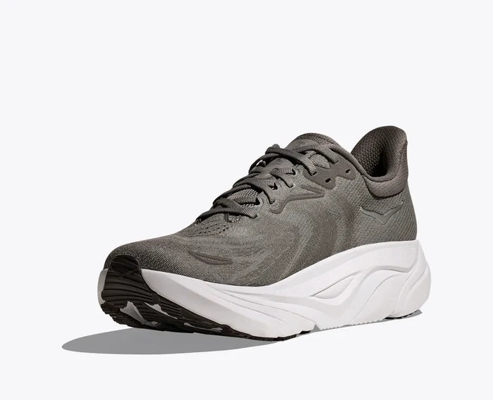 Gray athletic shoe with white sole on a light gray background