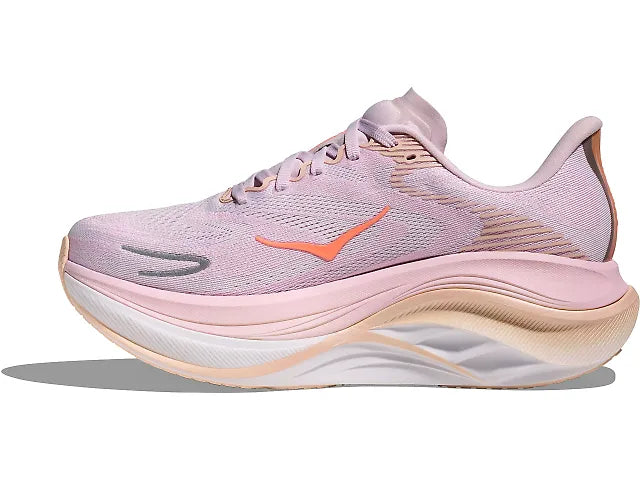 Pink running shoe with a white sole on a white background