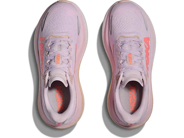 Pair of pink running shoes with orange accents on a white background