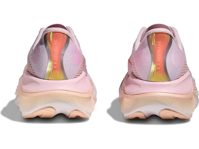 Pink athletic shoes with a thick sole on a white background
