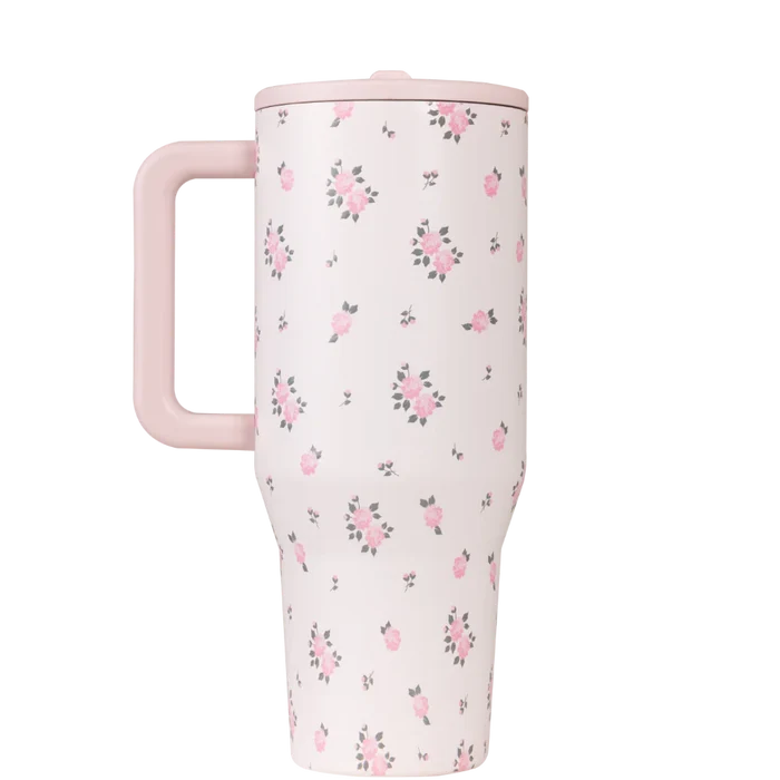 Floral-patterned travel mug with pink handle on a white background