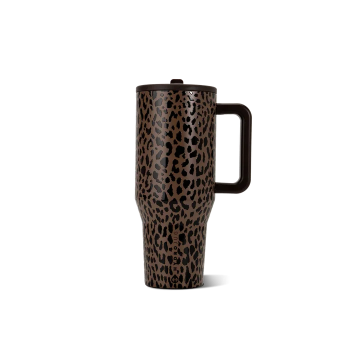 A travel tumbler with a brown and black leopard print pattern, featuring a dark brown handle and lid, shown on a solid white background.