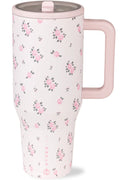Floral-patterned travel mug with a pink handle on a white background
