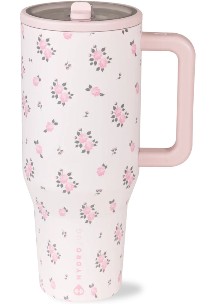 Floral-patterned travel mug with a pink handle on a white background