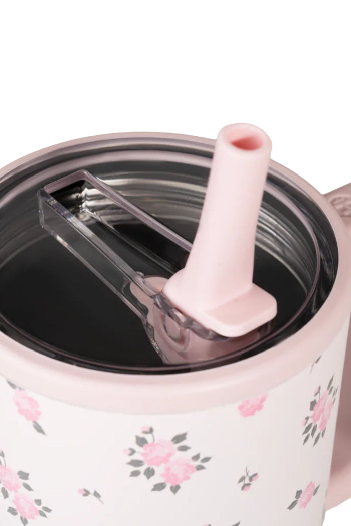 Pink floral-patterned tureen with a ladle on a white background