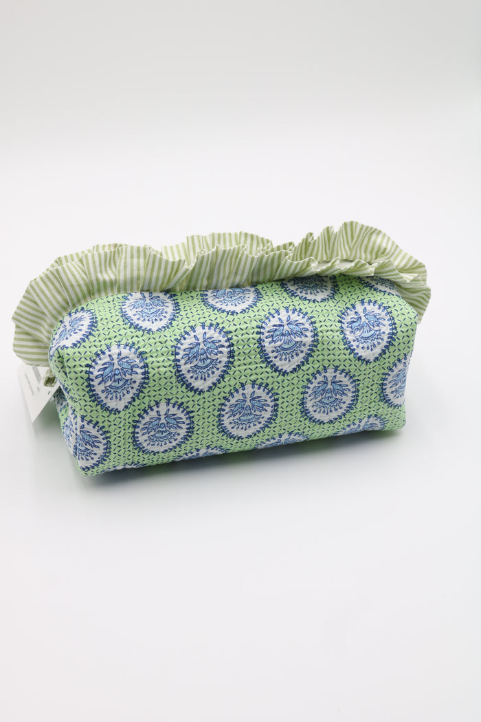 A fabric cosmetic pouch with a green and white striped ruffled top, featuring a green body printed with blue and white circular medallion patterns, on a white background.