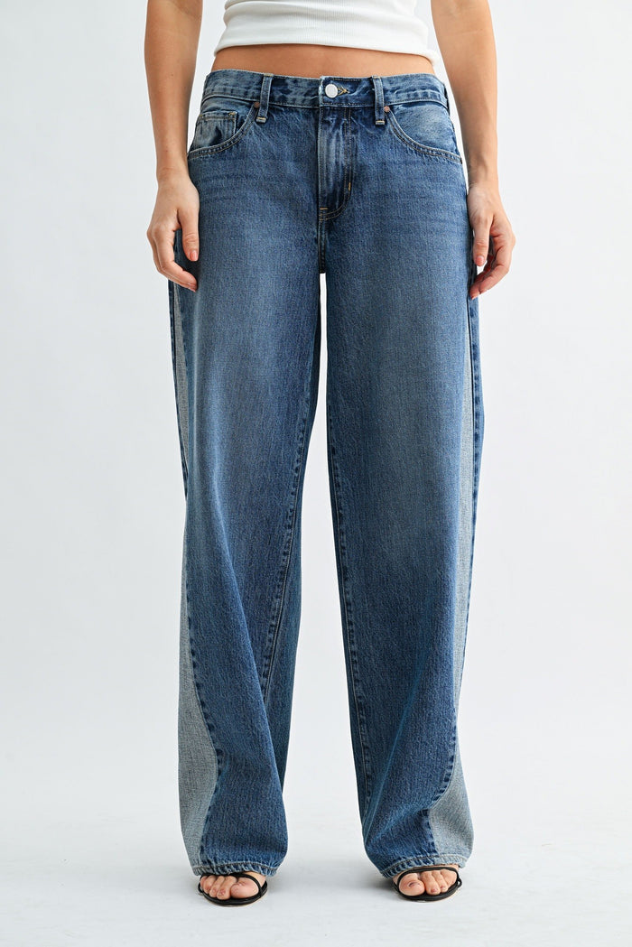 Blue jeans worn by a person on a white background