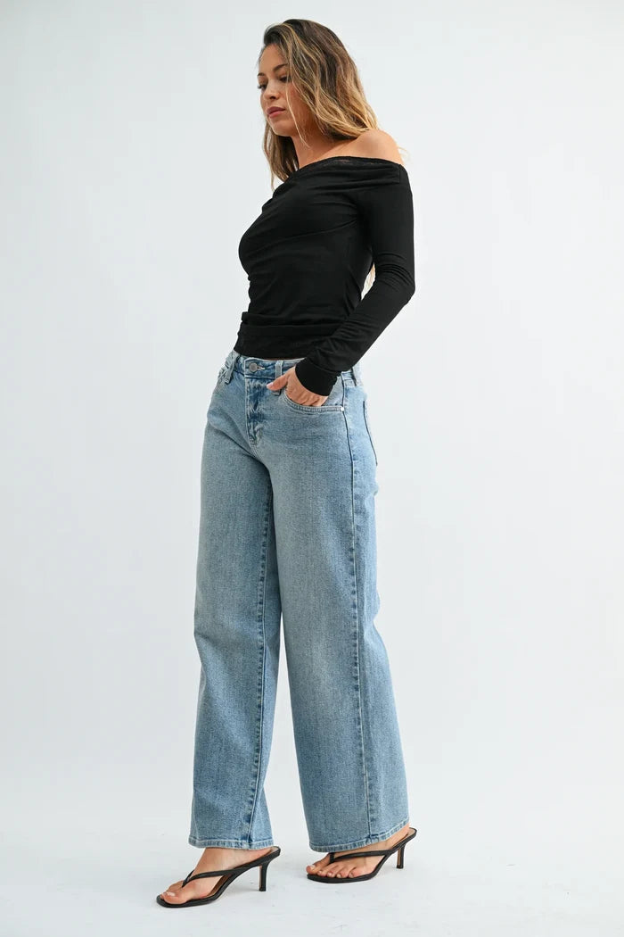 Woman modeling light wash straight leg denim jeans