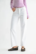 A model wearing white wide-leg cropped jeans, a light purple long-sleeve top, and black woven flats, shown from the waist down against a plain white studio background.