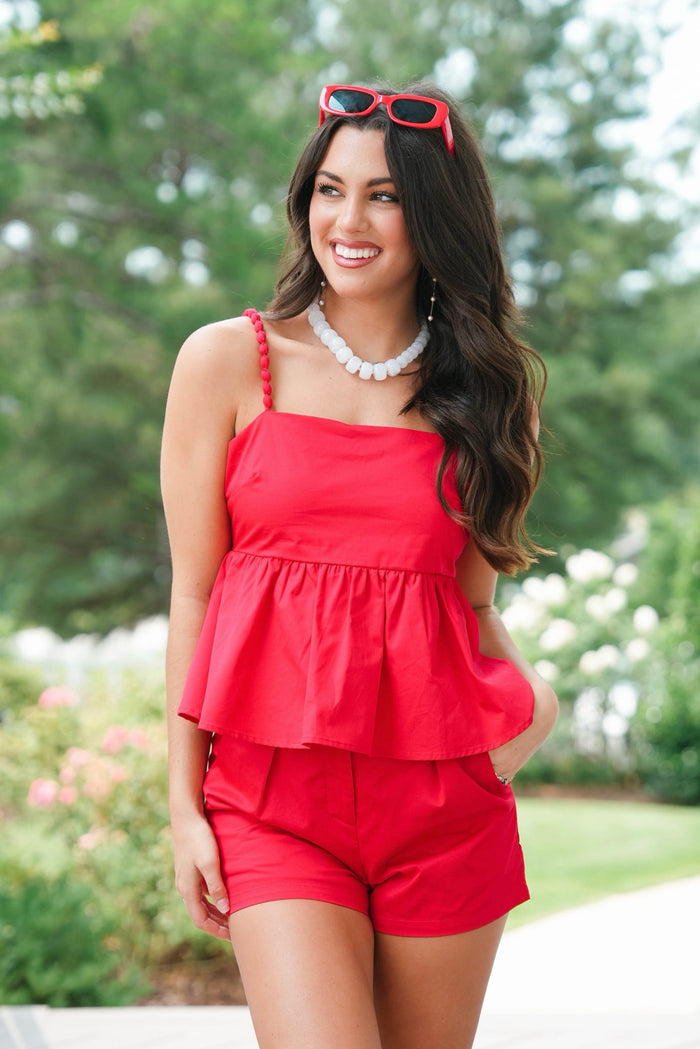 girl wearing matching red set outside