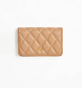 Beige quilted wallet on a white background