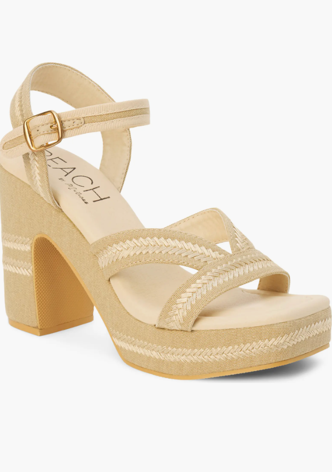 Beige sandal with woven details on a white background