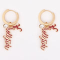 Gold 'roll tide' dangle earrings with diamond charm and Alabama 'A charm on a white background.