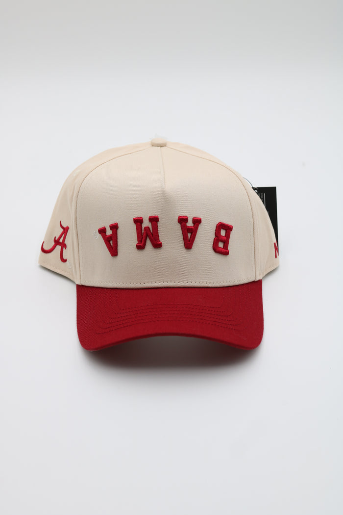 A cream and red baseball cap featuring the word 'BAMA' in red embroidered letters on the front and a red curved brim, shown against a plain white background.