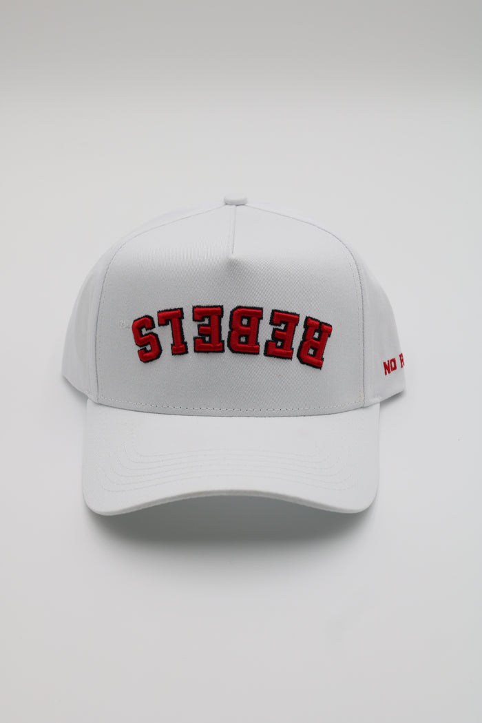A white baseball cap with 'REBEKS' embroidered in red arched letters on the front, shown against a light gray background.